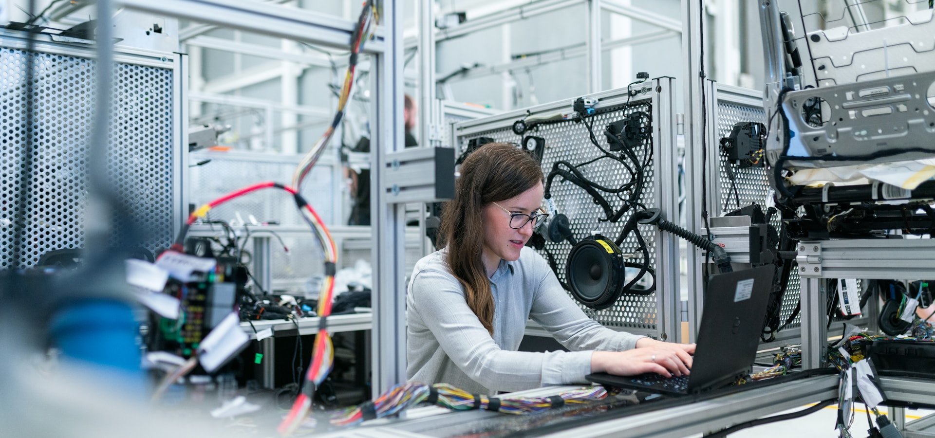 Engineer working among industrial machinery and electrical assemblies